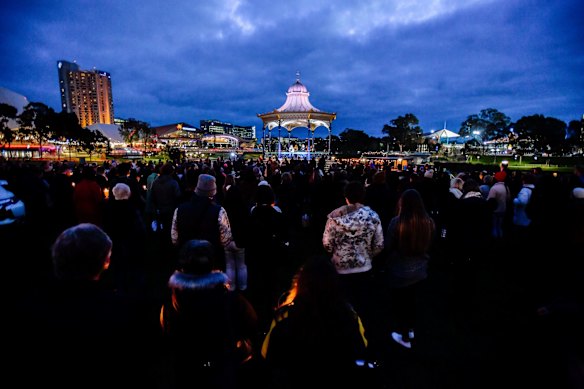 Supporters are seen holding candles and standing together in remembrance of Eurydice Dixon at a vigil held in Elder Park in Adelaide