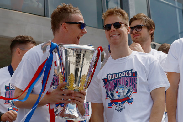 Jake Stringer and Lachie Hunter celebrate the Bulldogs’ 2016 premiership together.