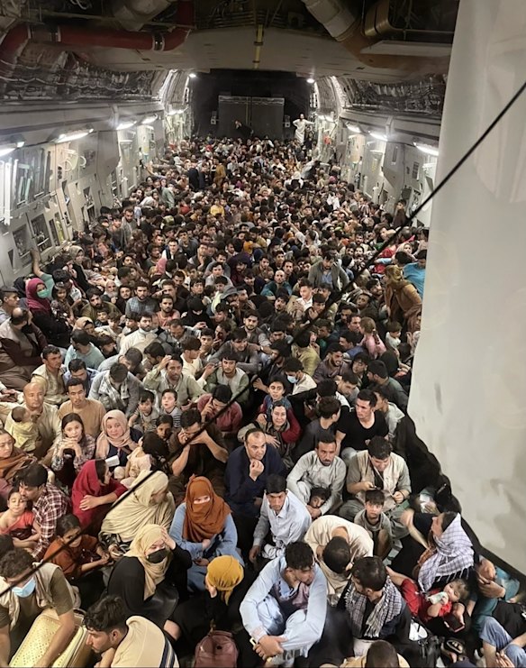 Afghan citizens pack inside a U.S. Air Force C-17 Globemaster III, as they are transported from from Hamid Karzai International Airport in Afghanistan. The Taliban on Sunday swept into Kabul, the Afghan capital, after capturing most of Afghanistan. 