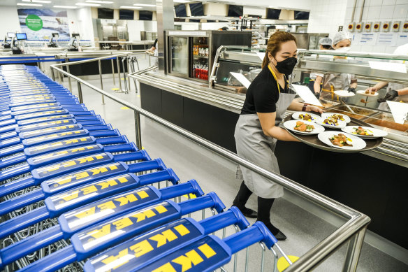 An employee serves plates of meatballs in coconut adobo sauce in the food hall during the opening of the Ikea store in Pasay City, Manila, the Philippines.