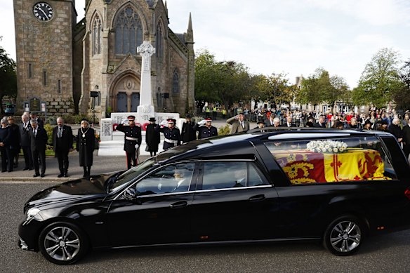 BALLATER, ABERDEENSHIRE - SEPTEMBER 11: People gather in tribute as the cortege carrying the coffin of the late Queen Elizabeth II passes by on September 11, 2022 in Ballater, United Kingdom. Elizabeth Alexandra Mary Windsor was born in Bruton Street, Mayfair, London on 21 April 1926. She married Prince Philip in 1947 and ascended the throne of the United Kingdom and Commonwealth on 6 February 1952 after the death of her Father, King George VI. Queen Elizabeth II died at Balmoral Castle in Scotland on September 8, 2022, and is succeeded by her eldest son, King Charles III. (Photo by Jeff J Mitchell/Getty Images)