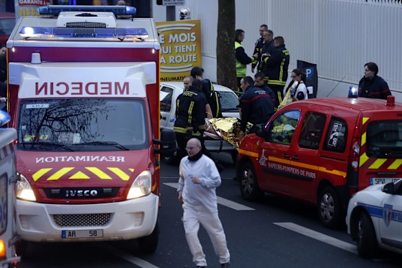 Police, paramedics and firefighters at the scene of the shooting in the south Paris on Thursday, January 8. 