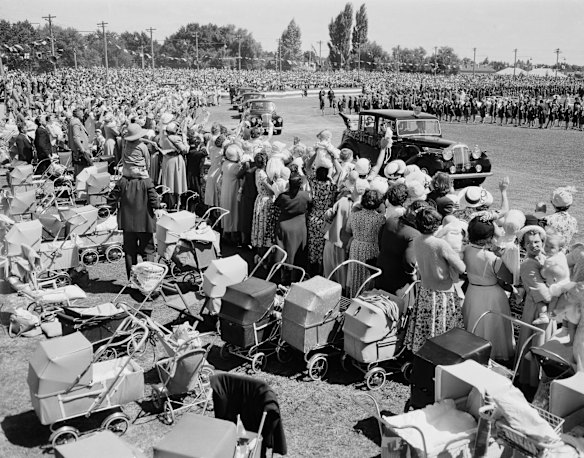 Crowds of mothers and babies in prams cheer as they view the royal motorcade with Queen Elizabeth II and Prince Philip during their 1954 tour of Australia.