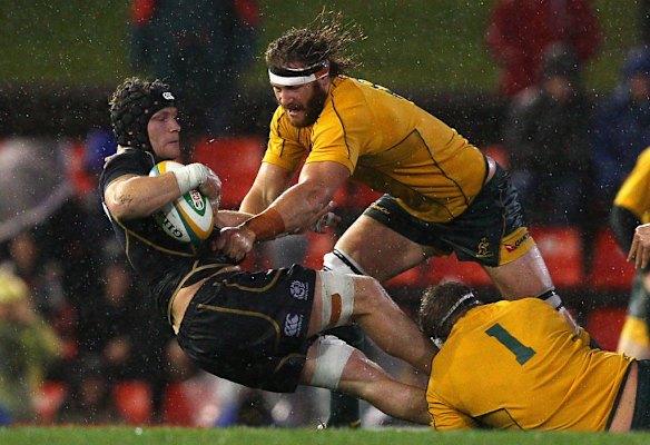 Scott Higginbotham of Australia tackles Ross Rennie of Scotland during the International Test match between the Australian Wallabies and Scotland at Hunter Stadium on June 5, 2012 in Newcastle, Australia.