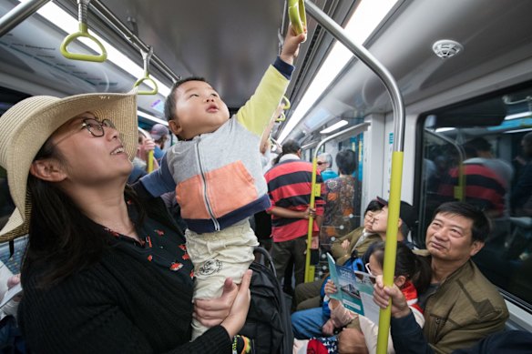 Evonne Shen with son Lucas, ride the train for the first time.