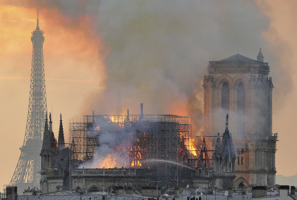 Flames and smoke rise from the blaze after the spire toppled over on Notre Dame.