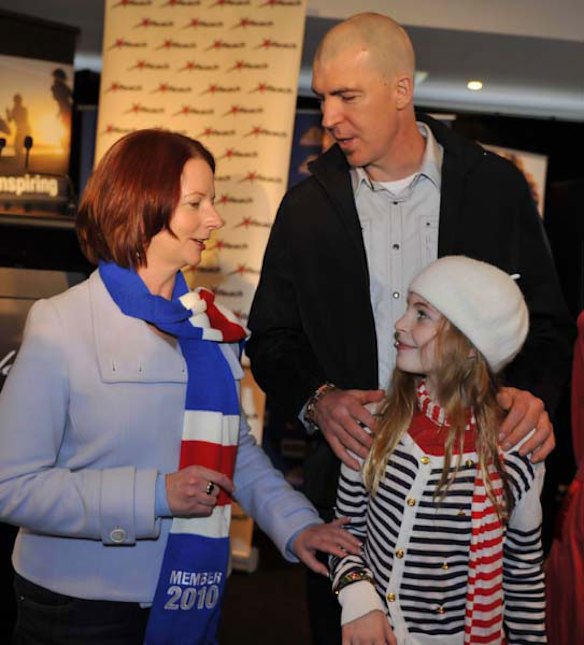 Julia Gillard with Melbourne Football Club president Jim Stynes and his daughter Matisse.