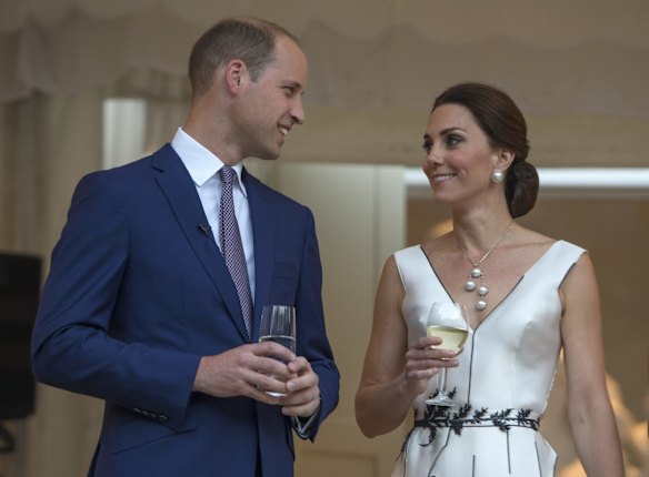 July 17- Kate Middleton wears a white dress by Polish designer, Gosia Baczyńska, as she and husband Prince William enjoy a toast to the Queen at the Queen's Birthday Garden Party at the Orangery on day one in Poland.