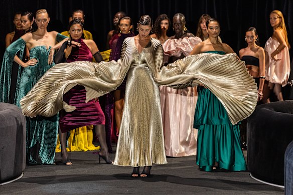 Taylor Hill (centre) rehearsing for the L’Idee Woman show at Australian Fashion Week, with Gemma Ward (far left) in green, Jessica Gomes in red and Shanina Shaik in green (right).