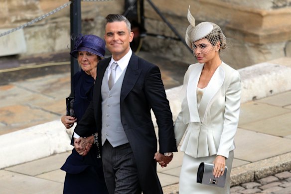 Robbie Williams, Ayda Field and Gwen Field, left, arrive for the wedding of Princess Eugenie of York and Jack Brooksbank.