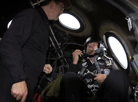 Richard Branson listens to preflight instructions from Lead Project Engineer Bob Morgan as he prepares to fly on Virgin Mothership Eve.