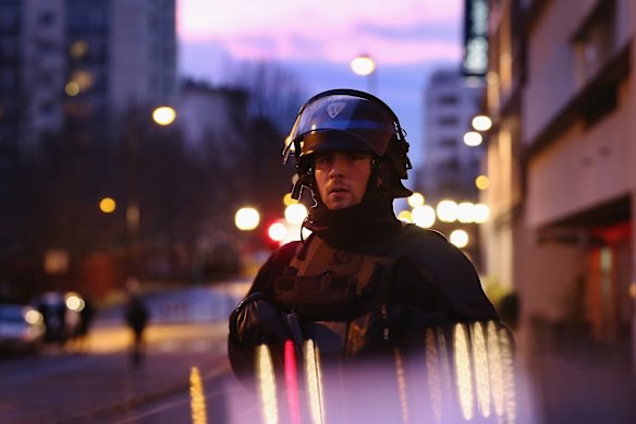 Police watch at the hostage situation at Port de Vincennes.