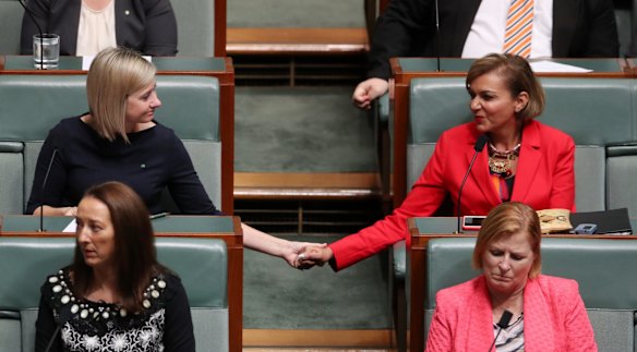 Susan Lamb holds hands with Anne Aly as Opposition Leader Bill Shorten delivered a statement to the House about the death of Binni Kirkbright-Burney the son of MP Linda Burney during question time at Parliament House in Canberra on Wednesday 25 October 2017. 
