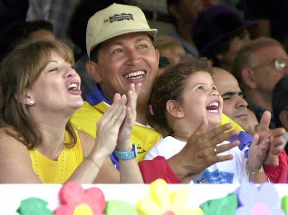 In this July 15, 2001 file photo, Venezuela's President Hugo Chavez, center, his wife Marisabel with their daughter Rosa Ines watch a parade on Children's Day in Caracas, Venezuela.