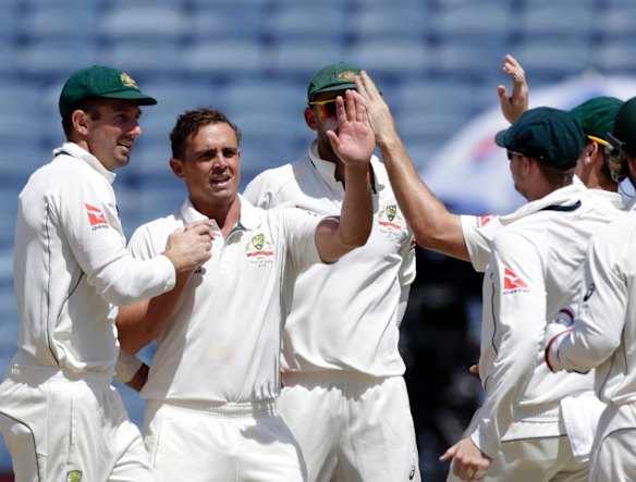 Australia's Steve O'Keefe, second left, and Nathan Lyon celebrate after Murali Vijay's wicket.