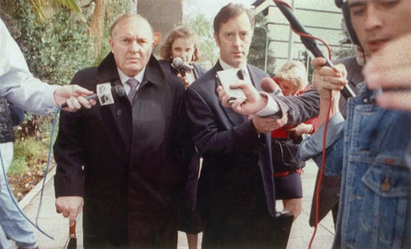 Alan Bond is beseiged by reports after leaving court, July 4, 1994. 
