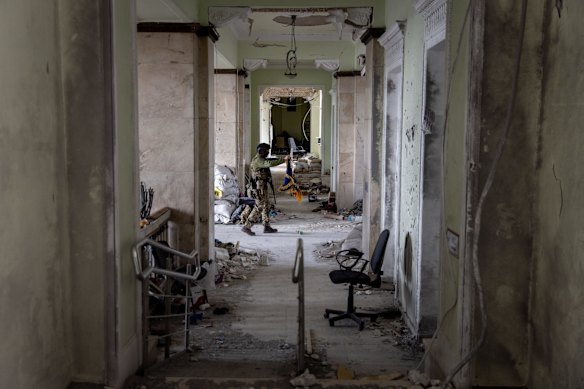 A soldier walks through the destroyed Kharkiv Regional State Administration building in Kharkiv. More than half Kharkiv's 1.4 million people have fled the city since Russia's invasion on Feb. 24, which was followed by weeks of intense bombardment.