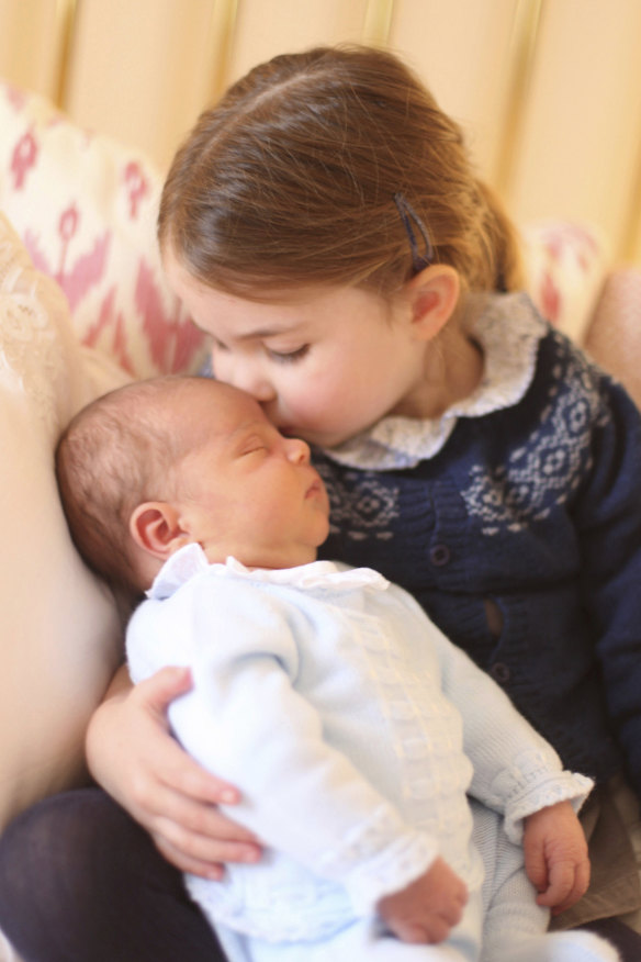 Britain's Princess Charlotte cuddles her brother Prince Louis. 