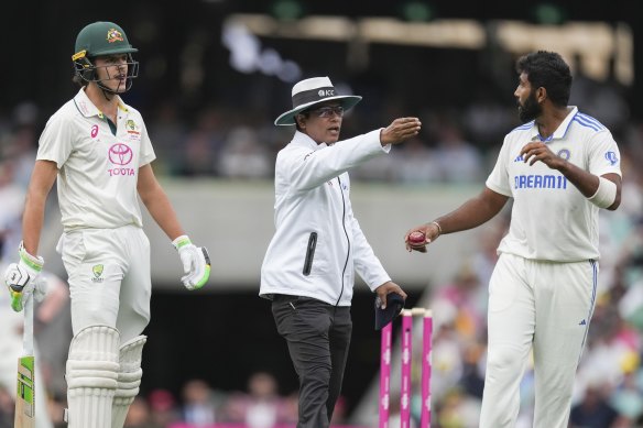 Battle lines: Umpire Sharfuddoula Saikat gestures to Jasprit Bumrah, as he exchanges words with Sam Konstas after play ended on Friday.