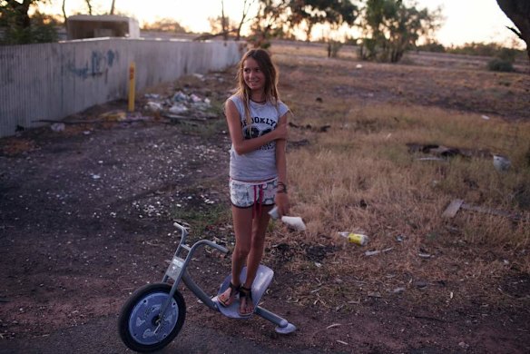 A young teenager on the streets in the early evening.