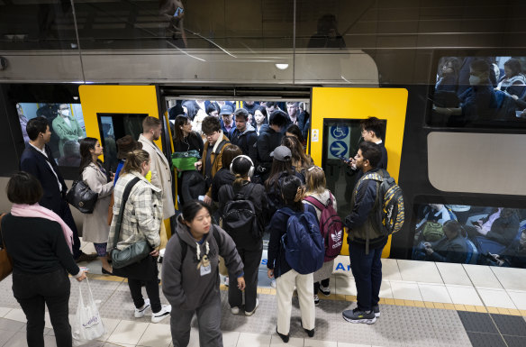 Passengers attempt to board a city bound train at Green Square station on a Tuesday morning in August.