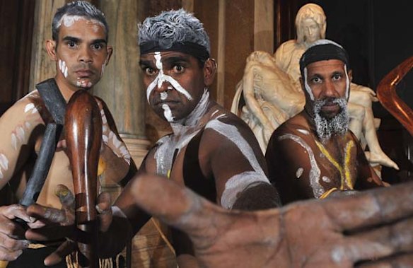 Indigenous dancers in front of a cast of Michelangelo's Pieta in Rome.
