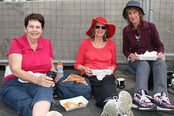 Enjoying fish and chips on the bridge are Denise Munns, Henny Santa and Gwendolyn Ungerer.