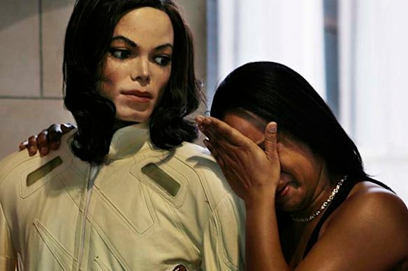 Shayla Ivy cries as she holds a wax replica of Michael Jackson outside of Madame Tussaud's Wax Museum at The Venetian Hotel and Casino in Las Vegas.