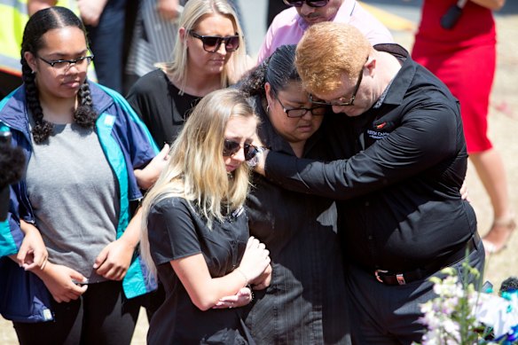 Dreamworld staff lay flowers after a private memorial service held on Friday at Dreamworld.