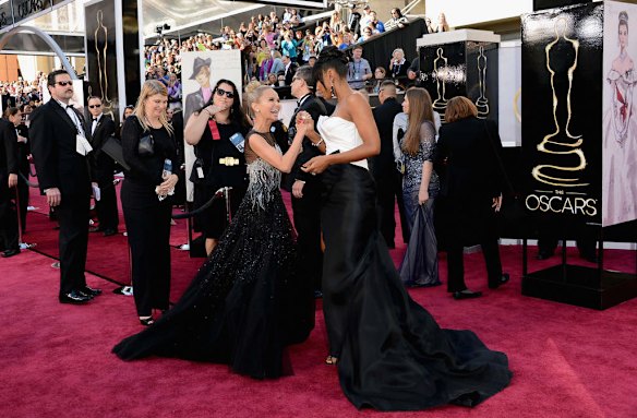 Actress-singer Kristin Chenoweth (L) and singer Kelly Rowland attend the Oscars at Hollywood & Highland Center on February 24, 2013 in Hollywood, California.