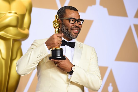 Jordan Peele, winner of the Oscar for best original screenplay for <i>Get Out</i>, poses in the press room.