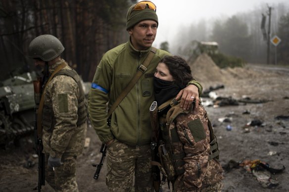 Ukrainian army soldier Igor, 23, embraces his wife, Dasha, 22, after conducting a military sweep for possible remnants of Russian troops after their withdrawal from villages on the outskirts of Kyiv.