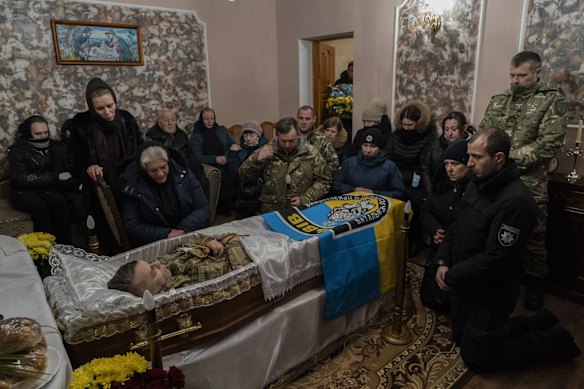 Relatives and friends mourn the body of senior police sergeant Roman Rushchyshyn in the village of Soposhyn, in the outskirts of Lviv, western Ukraine.