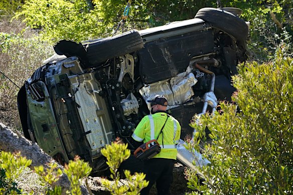 A vehicle rests on its side after a rollover accident involving golfer Tiger Woods on February 23, 2021, in California.