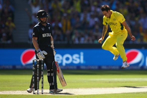 Mitchell Johnson leaps in joy after catching Kane Williamson off his own bowling.