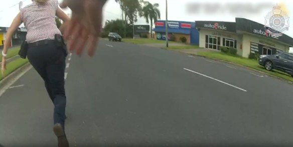 Dramatic vision shows the boy running down a street before being apprehended by an officer.