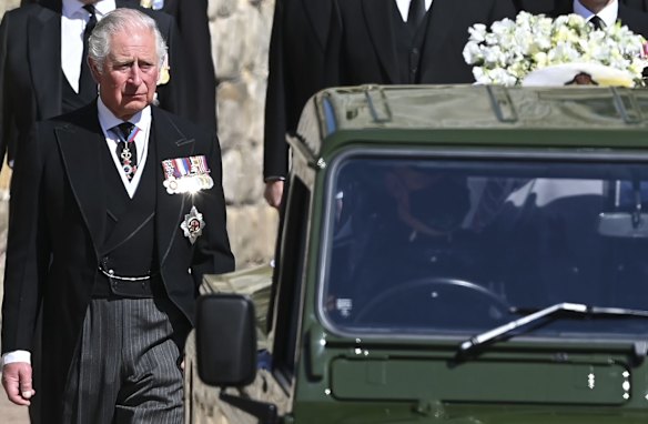 Britain's Prince Charles follows the coffin as it makes it's way past the Round Tower.