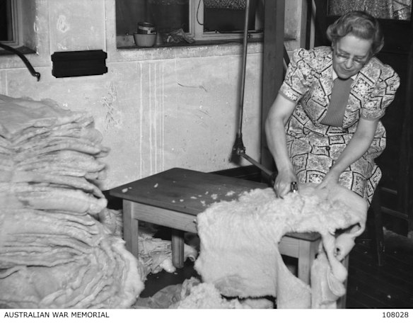 A CWA member with a fleece used to make warm clothes to help the soldiers overseas. 