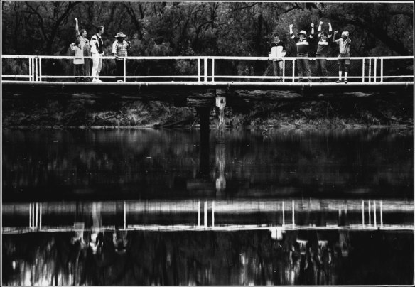 On the standing bridge in Mungindi are supporters for the opposing State of Origin teams - NSW to the left, Queensland to the right. May 15, 1993.