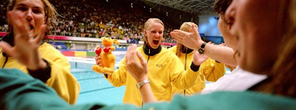 Naomi Castle rejoices with fellow Australian team members, after they won the gold medal in the women's water polo.