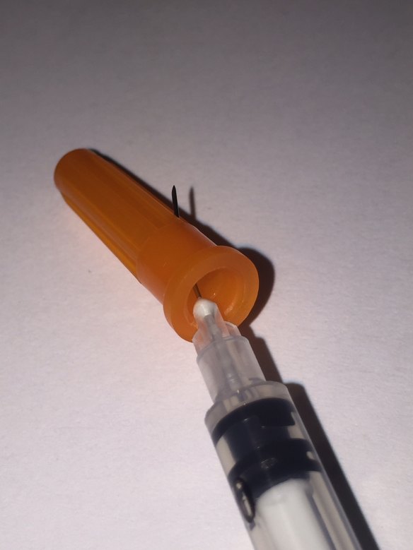 One of the new Terumo syringes piercing its cap. 