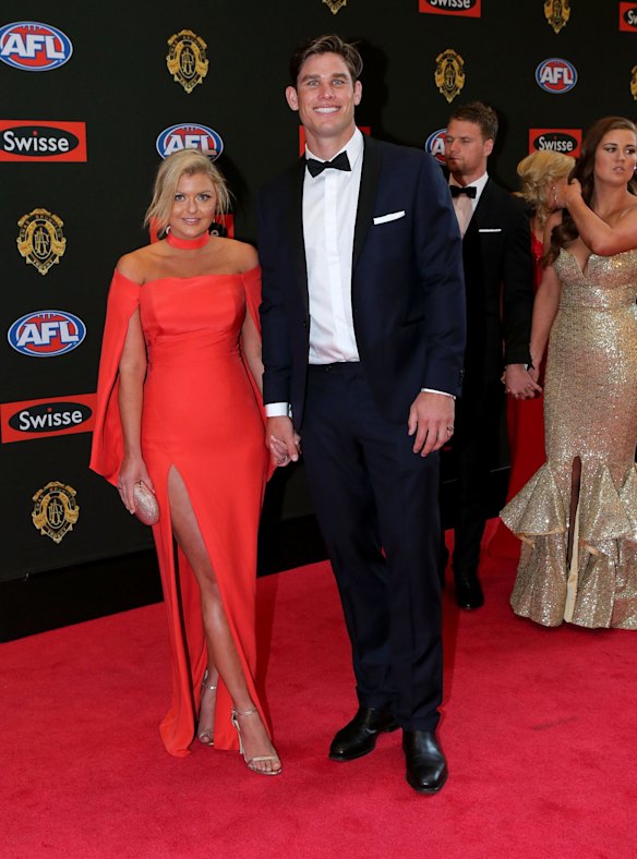 Geelong footballer Tom Hawkins  poses for a photo with his partner Emma Clapman on the red carpet ahead of the 2015 AFL Brownlow Medal count at Crown Palladium.