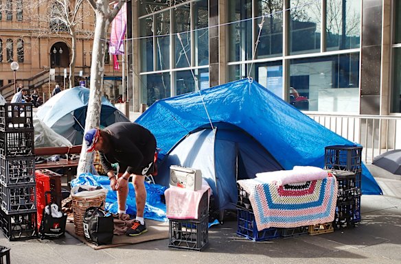 A man prepares to remove his belongings from Martin Place.