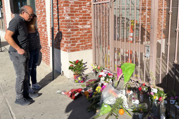 Jan Alejandro and his daughter Arlene pay their respects at the site of the Monterey Park mass shooting.