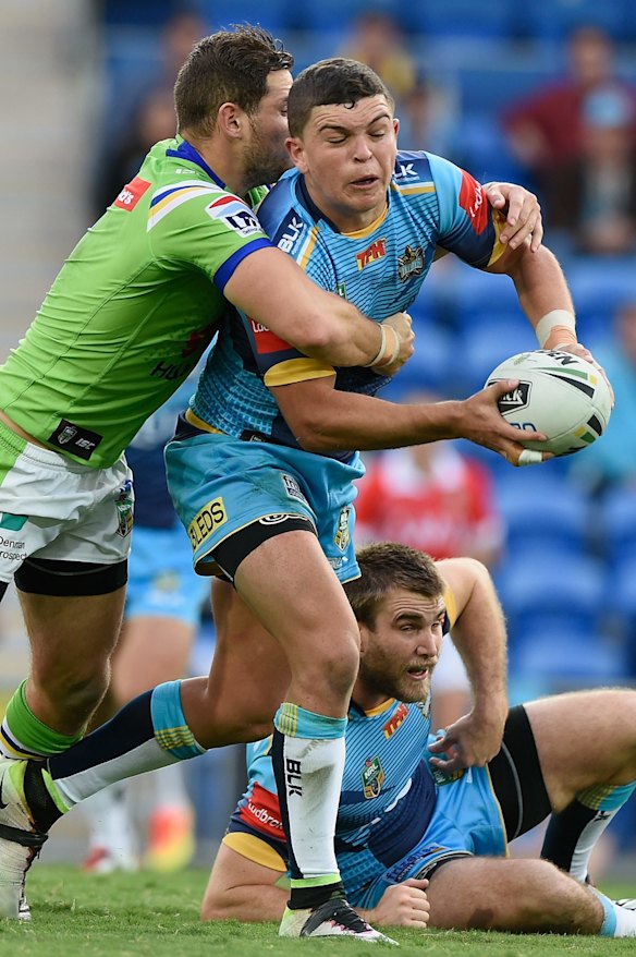 Ash Taylor of the Titans is tackled.