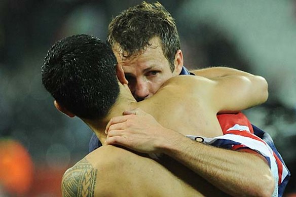 Tears ... Lucas Neill hugs Tim Cahill.