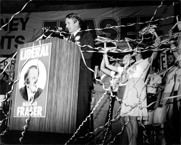 The Prime Minister Malcolm Fraser on stage speaking with supporters cheering amidst thrown streamers, at the Sydney Opera House.  On the occasion of 1977  Liberal - Country Party coalition election victory.
6 December 1977.

Scanned from the Malcolm Fraser file in Fairfax Photo Library (Sydney) hard copy print collection.