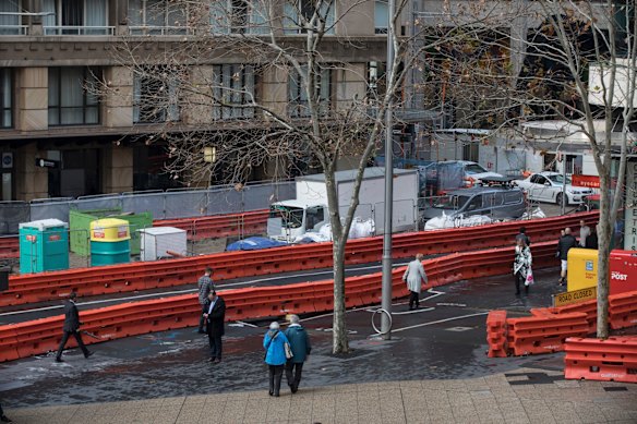 Pedestrians navigate the construction and barricades on George Street between Bridge and Jamison Street caused by the construction of the light rail.