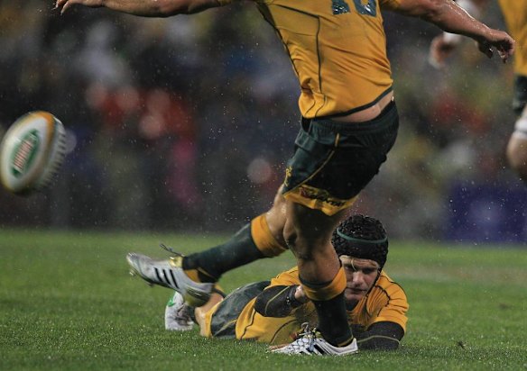 Berrick Barnes holds the ball for a place kick. The wind was howling in so the placement of the ball on the tee was impossible without some assistance.