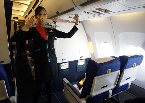 PC Air transsexual flight attendant Chayathisa Nakmai, 24, demonstrates in-flight safety to passengers.